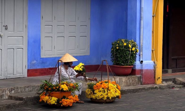 lady and her flower vendor in Hoi An, Vietnam