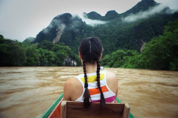 a female tourist is riding boat