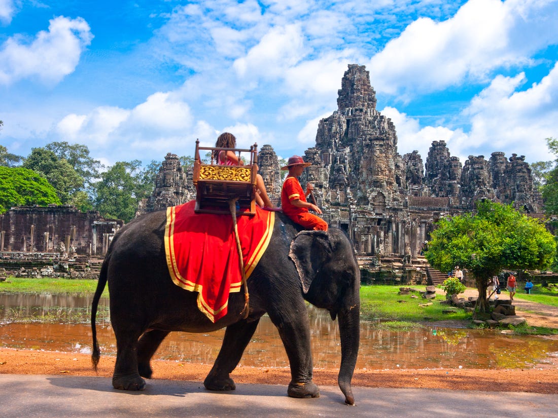 Riding elephants across Angkor Wat before being banned