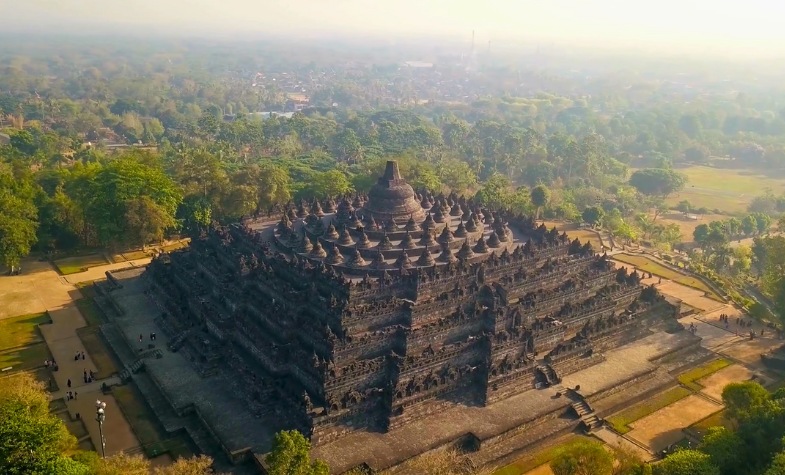 Borobudur Temple with pyramid structure and Buddha statues.
