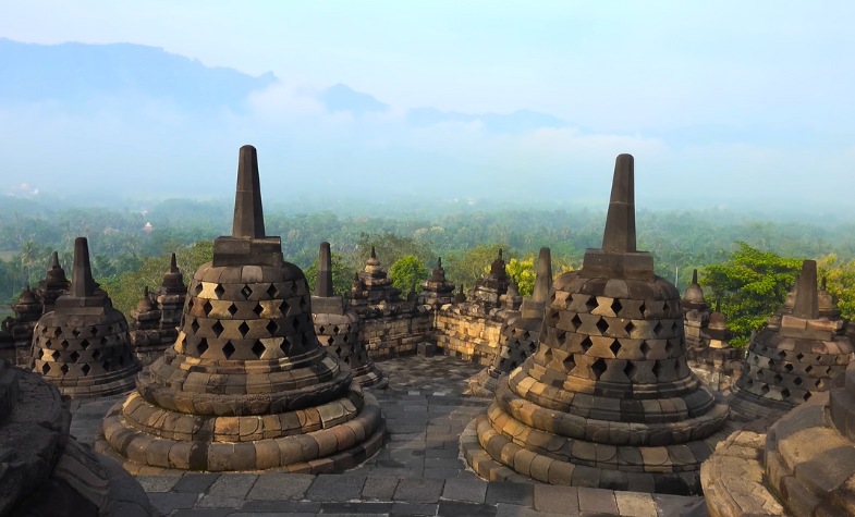 Reliefs, Buddha statues, and sunrise at Borobudur.